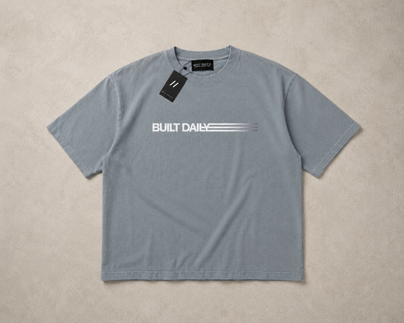 Grey oversized Built Daily top with subtle front chest branding.