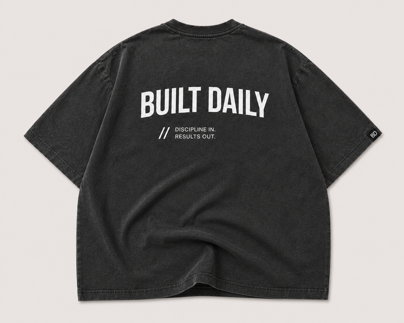 Black oversized Built Daily top with large back graphic and slogan.