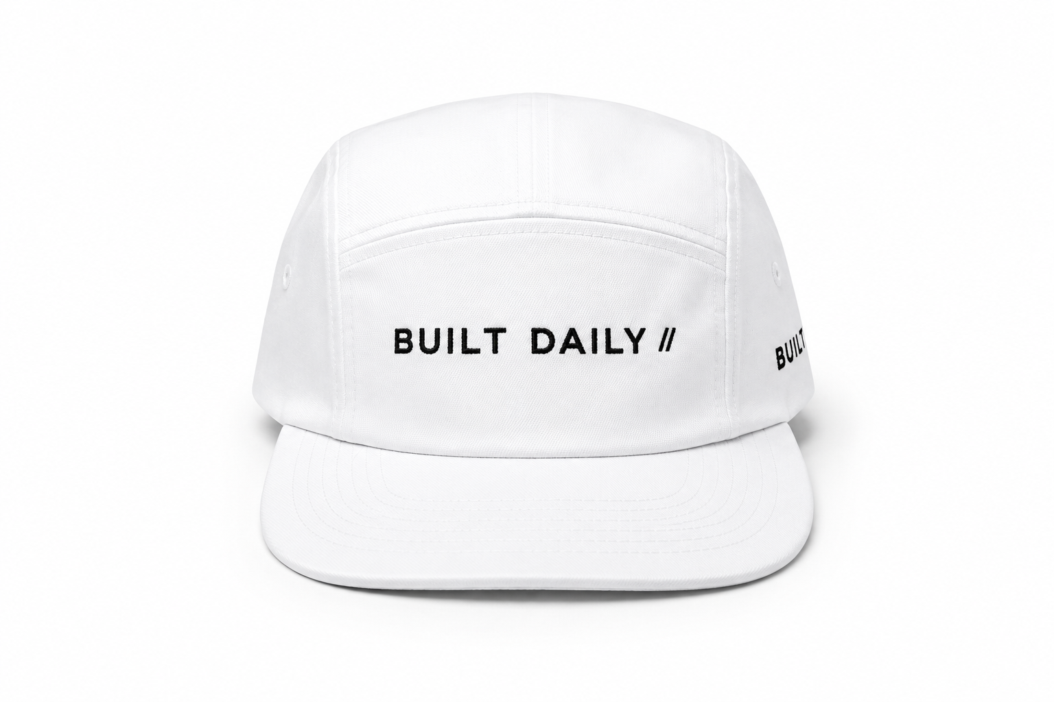 Built Daily off-white cap flat lay.